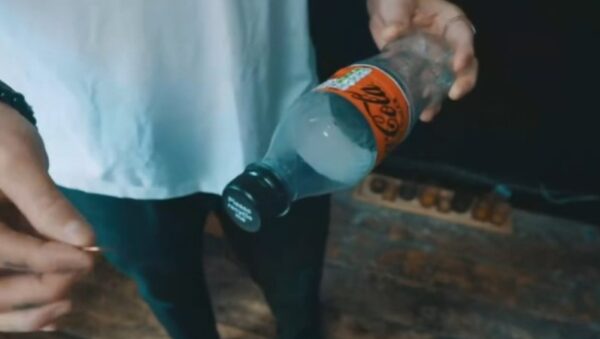 Slo Mo Coin in Bottle by Lloyd Barnes
